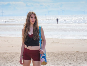 Young woman standing on beach