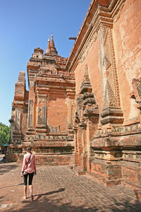 Rear view of women in temple against building