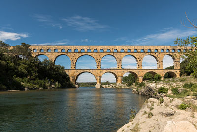 Bridge of aqueduct over river against sky in france