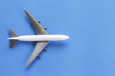High angle view of airplane against blue background