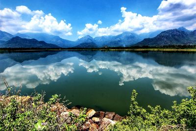 Scenic view of lake and mountains against sky