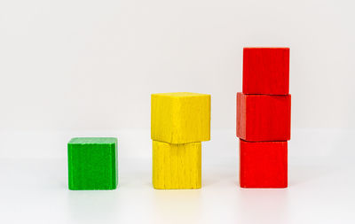 Stack of multi colored toy against white background