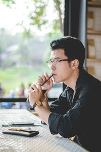 Young man drinking coffee at restaurant