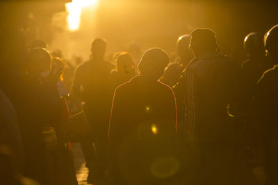 Crowd in city during sunny day