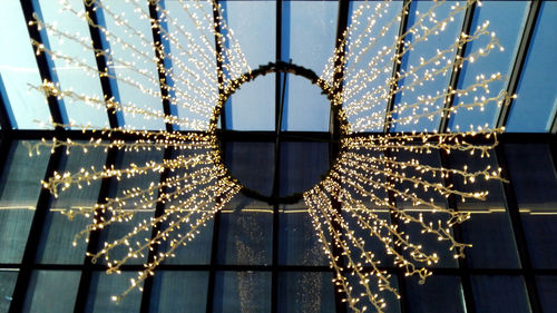 Low angle view of illuminated lanterns hanging on window