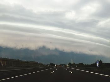 Road leading towards dramatic sky