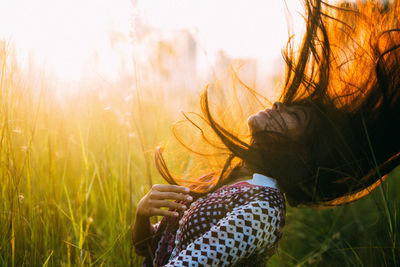 Woman in wheat field against sky