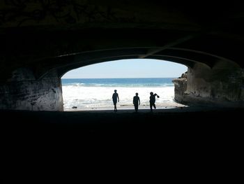 Silhouette of people in tunnel