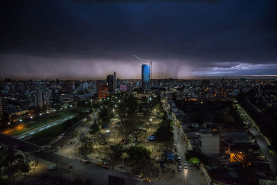 High angle view of illuminated city street against sky at dusk