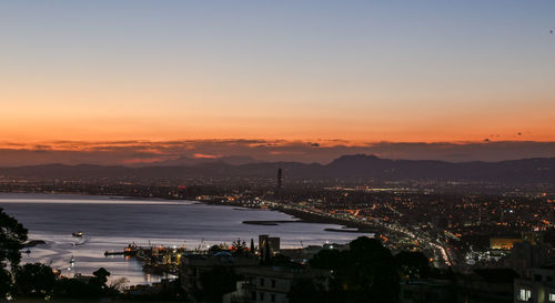 High angle view of illuminated buildings against sky during sunset