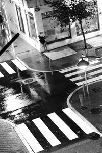 High angle view of wet street amidst buildings