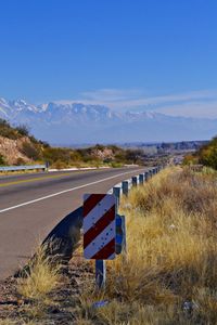 Road signs on landscape against sky