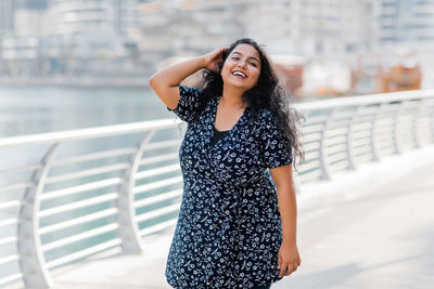 Portrait of a laughing indian woman while walking around the city. positive emotions, cheerful girl.