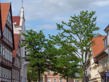 Low angle view of buildings in town against sky