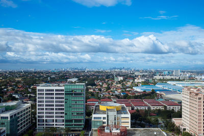 Cityscape against cloudy sky