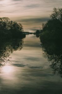 Scenic view of lake against sky at sunset