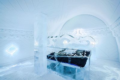 Bed in frozen room of ice hotel at jukkasjarvi