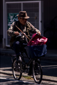 Portrait of man with bicycle on street