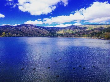 Scenic view of lake against cloudy sky