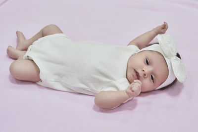 High angle view of cute baby boy sleeping on bed