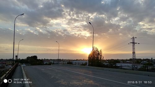 Street against sky during sunset