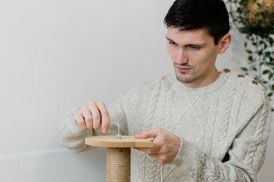 A young man collects a scratching post.