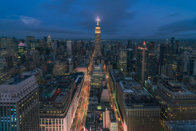 Aerial view of city lit up at night