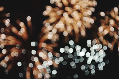 Low angle view of illuminated christmas tree against sky at night