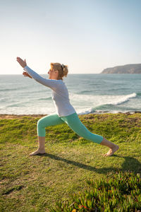 Full length of woman doing yoga at park