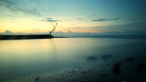 Scenic view of lake against sky at sunset