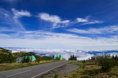 View of country road against cloudy sky