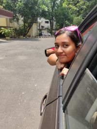 Portrait of woman on road in city