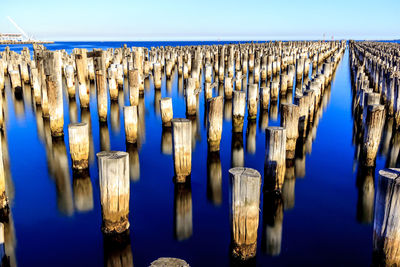 Panoramic view of wooden posts and pillars at princes pier against sky