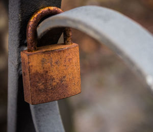 Close-up of rusty padlock on metal