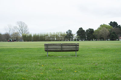 A wooden bench at the park.view from behind.