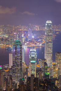 Illuminated cityscape against sky at night