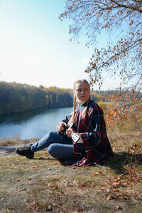 Portrait of woman sitting on field