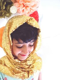 Close-up of smiling girl wearing golden sequin hijab