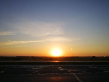 Scenic view of silhouette field against sky during sunset