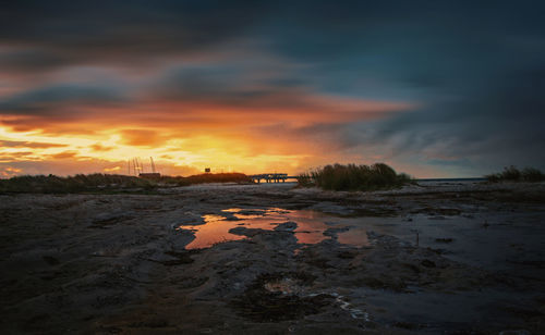 View of beach against cloudy sky