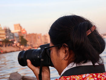 Portrait of woman photographing