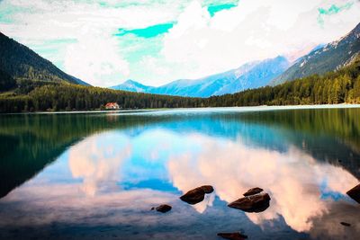 Scenic view of lake and mountains against sky