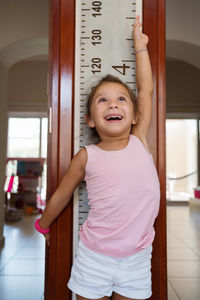 Little cute girl want to grow up measuring height