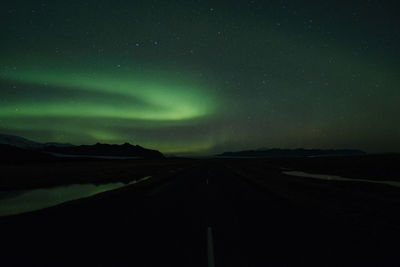 Scenic view of landscape against sky at night