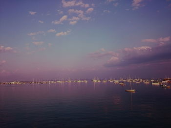 Sailboats in sea against sky