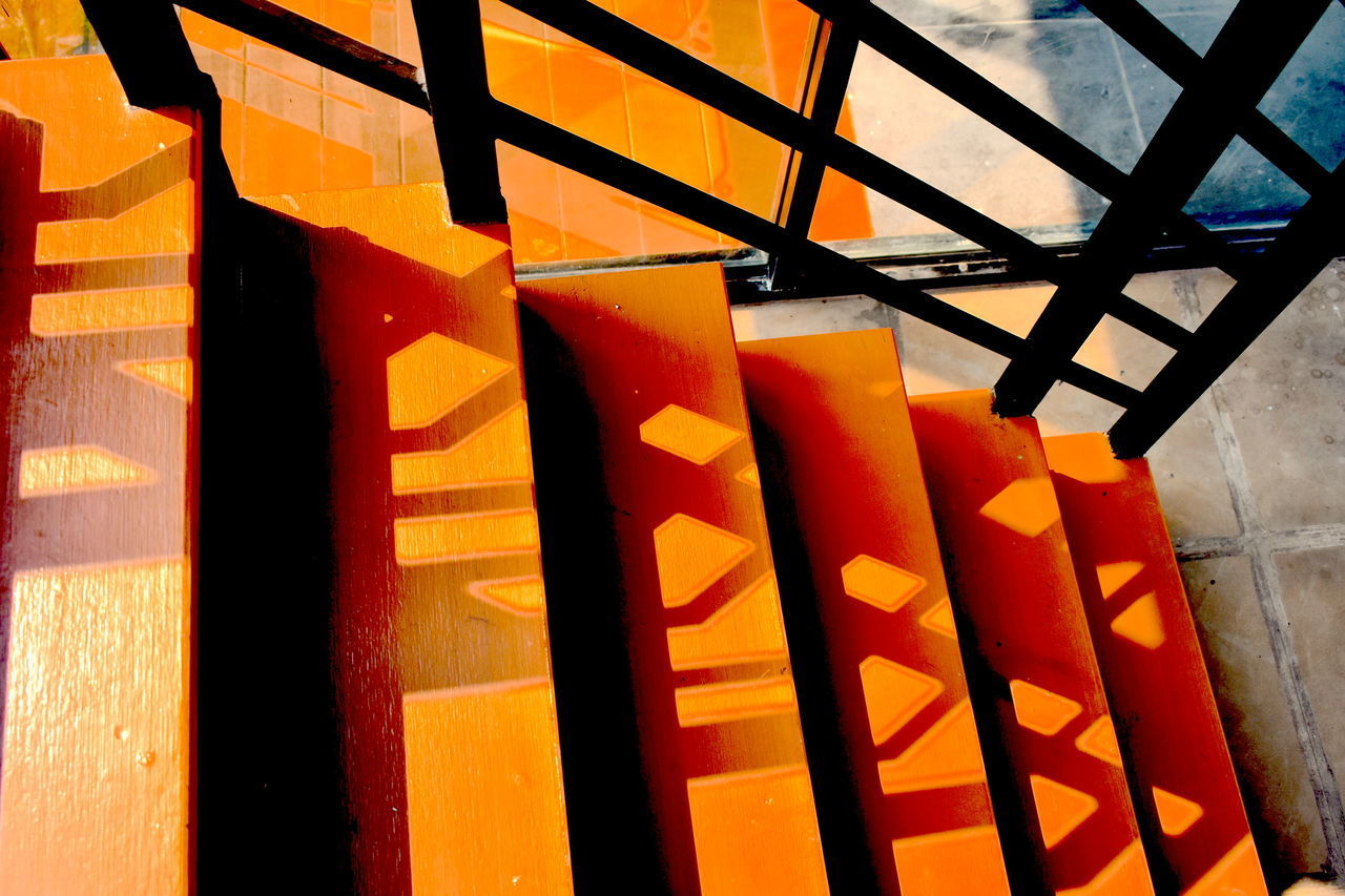 CLOSE-UP OF ORANGE SHADOW ON WALL