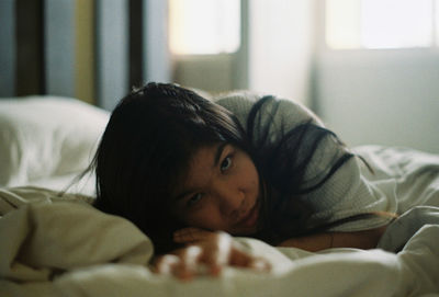 Portrait of boy lying in bed