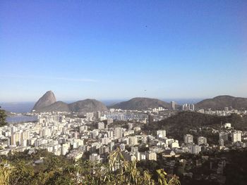 Cityscape against clear blue sky