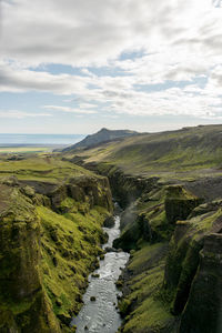 Scenic view of waterfall against sky