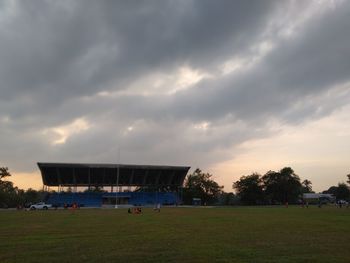 View of soccer field against cloudy sky